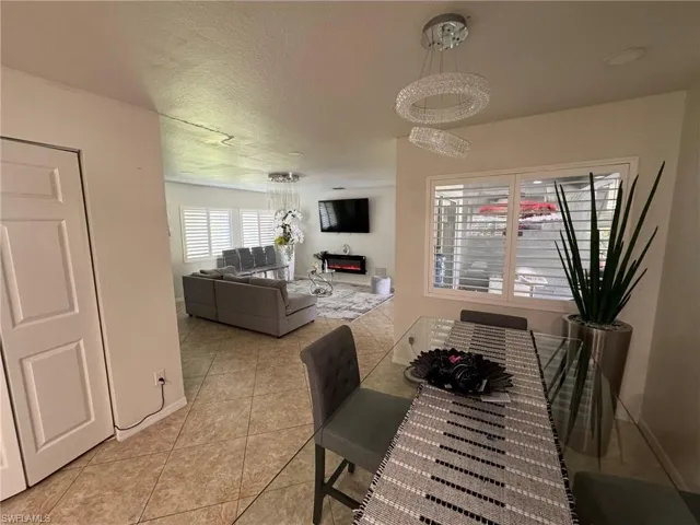 Dining space featuring light tile patterned floors