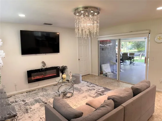 Tiled living room with an inviting chandelier
