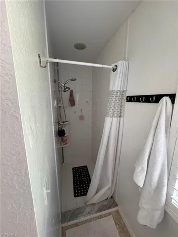 Bathroom featuring a shower with curtain