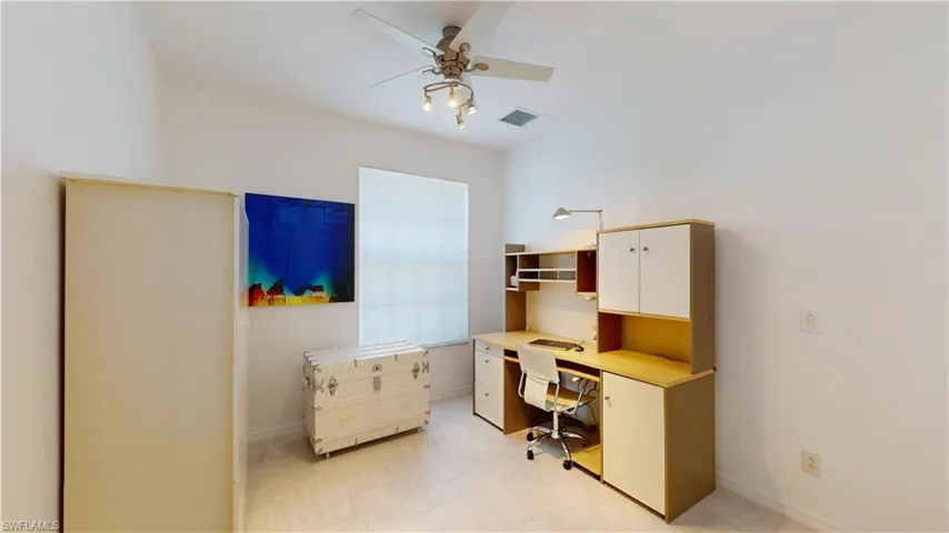 Office space with ceiling fan and baseboards