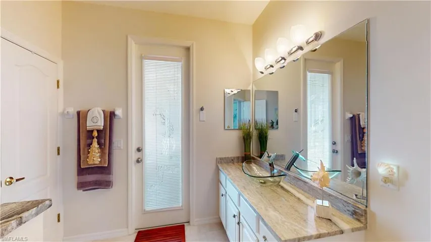 Bathroom with vanity, plenty of natural light, and light tile patterned floors