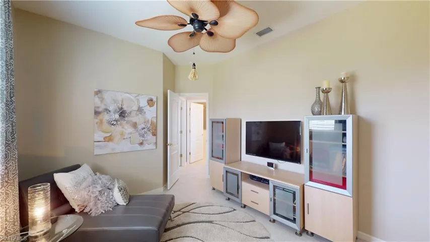 Living room with ceiling fan and light colored carpet