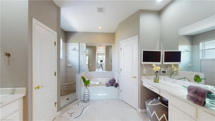 Full bath with vanity, a bath, and walk in shower