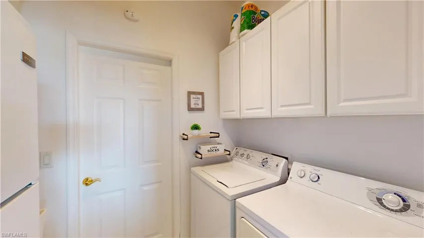 Laundry area with washing machine and clothes dryer and cabinet space