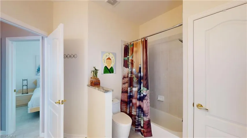 Bathroom featuring ensuite bathroom and shower / tub combo