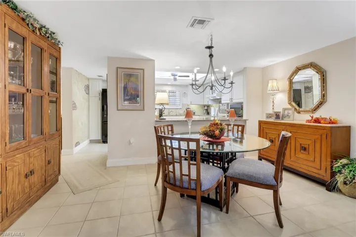 Dining area featuring a notable chandelier and light tile patterned floors