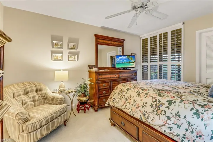 Bedroom with light carpet and ceiling fan
