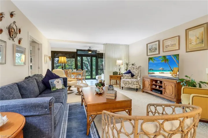 Carpeted living room with ceiling fan