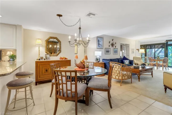 Dining room with a chandelier and light colored carpet