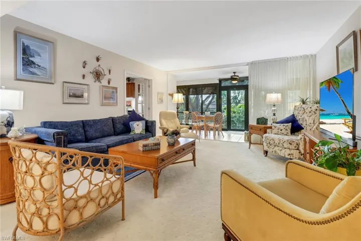 Living room featuring light carpet and ceiling fan