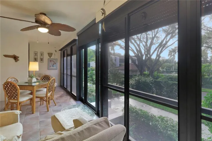 Sunroom featuring ceiling fan and plenty of natural light