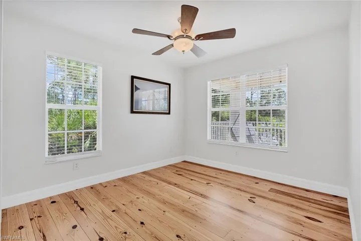 Spare room featuring ceiling fan and light wood-type flooring
