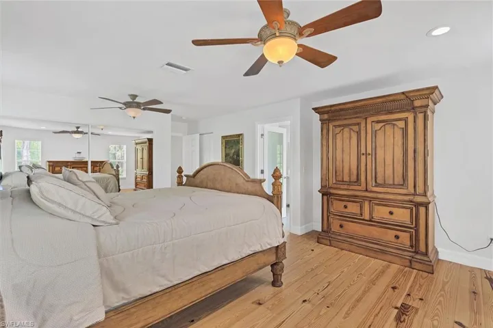 Bedroom with ceiling fan and light hardwood / wood-style floors