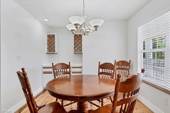 Dining area featuring a notable chandelier and light wood-type flooring