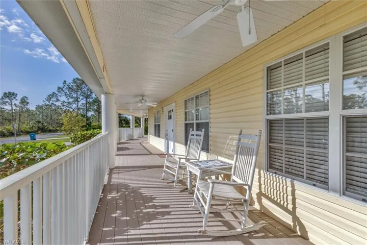 Deck with a porch and a ceiling fan