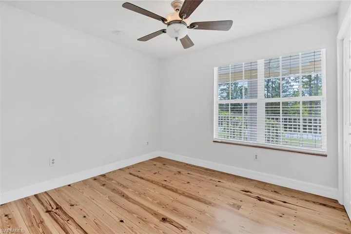 Unfurnished room featuring light hardwood / wood-style flooring and ceiling fan