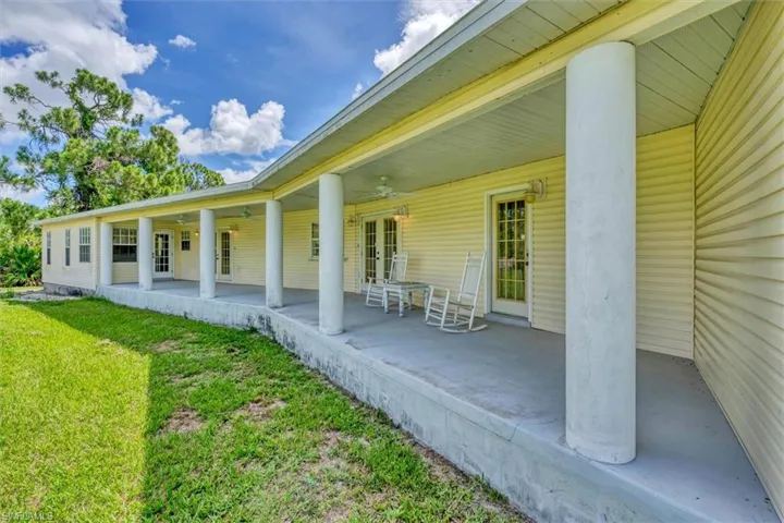 Back of house featuring a yard