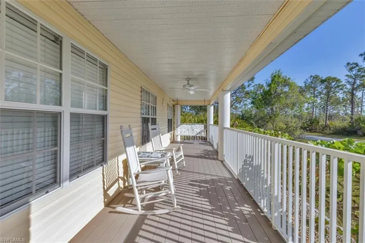 Wooden deck with a porch and ceiling fan