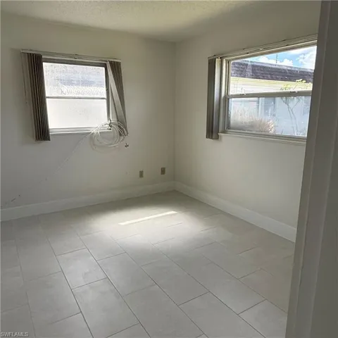 Spare room featuring a textured ceiling and plenty of natural light