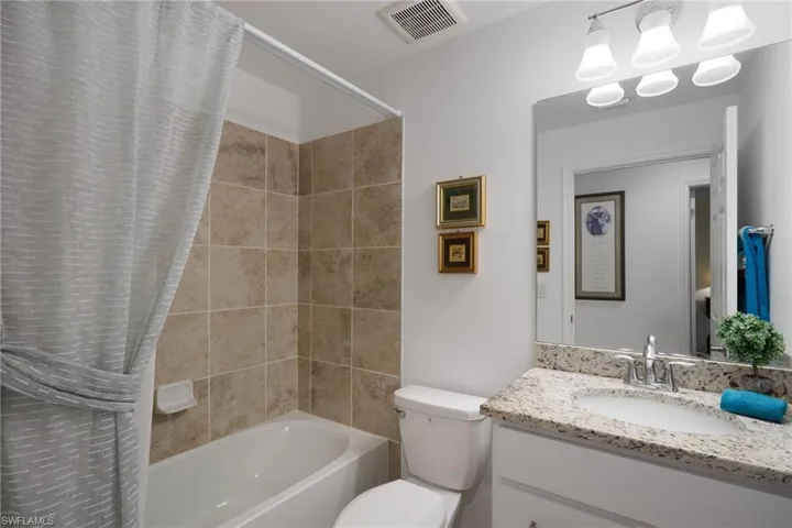 Full bathroom featuring vanity, toilet, and shower / bath combo