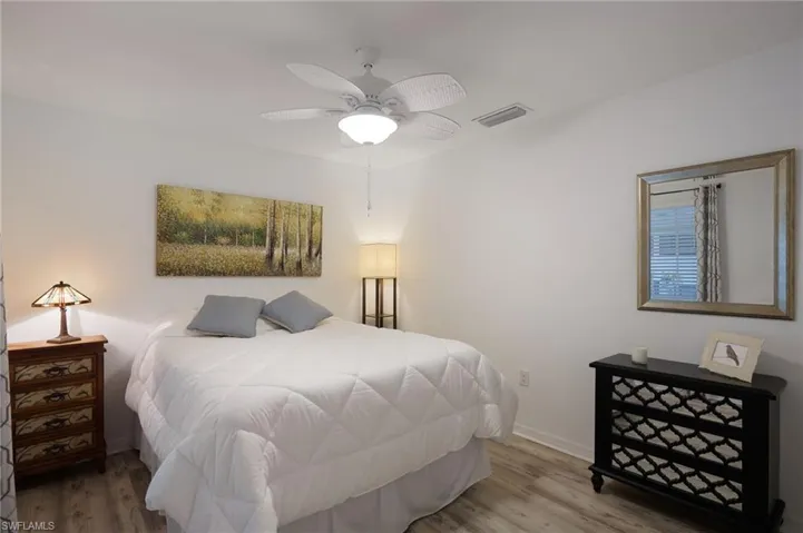 Bedroom with hardwood / wood-style flooring and ceiling fan