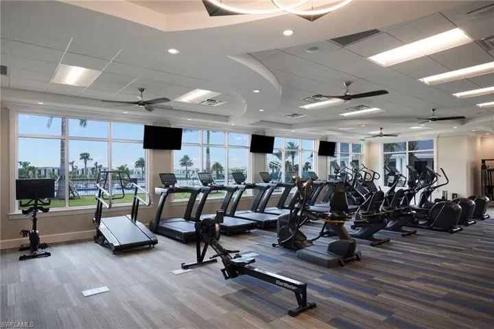 Exercise room featuring a paneled ceiling and carpet flooring