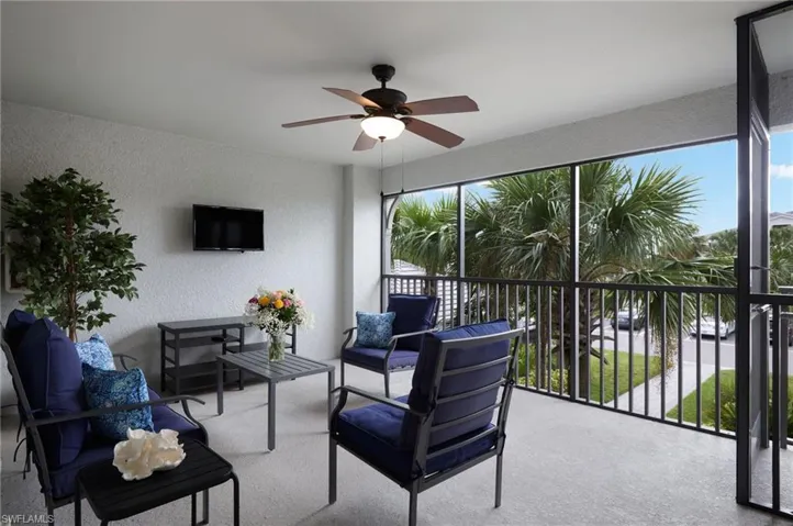 Front Sunroom / solarium with a wealth of natural light and ceiling fan