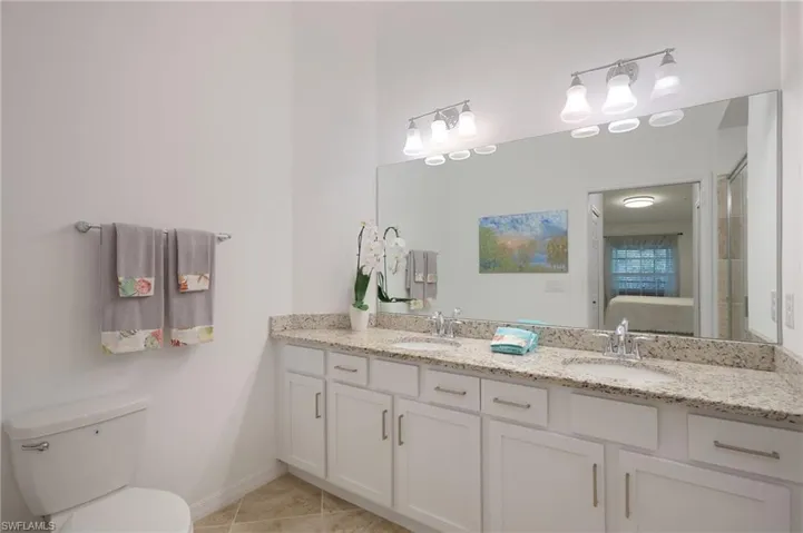 Bathroom with vanity, toilet, and tile patterned floors