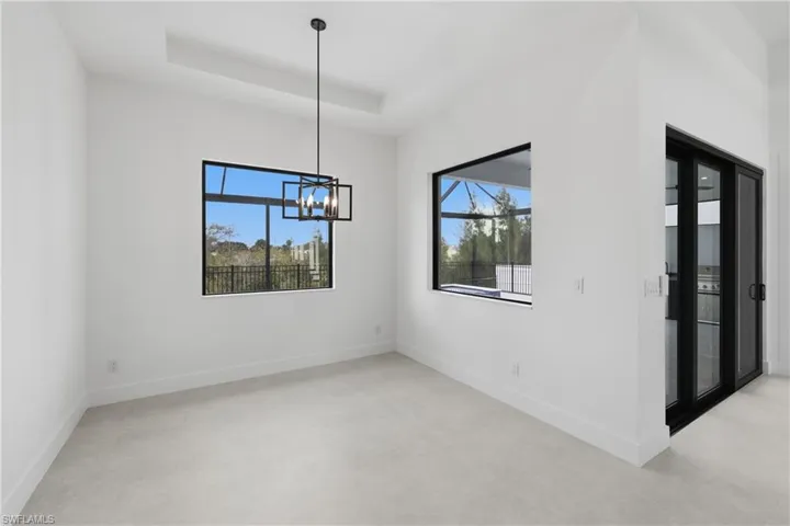 Spare room featuring baseboards and a tray ceiling
