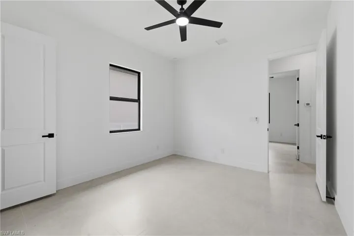 Unfurnished bedroom featuring a ceiling fan and baseboards