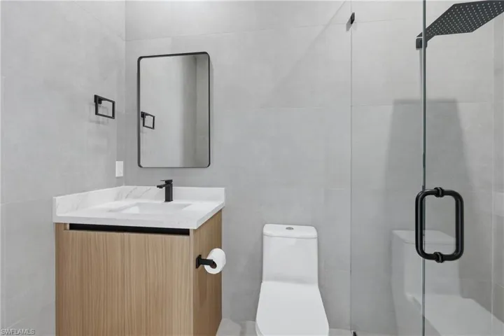 Full bath featuring vanity and a shower stall