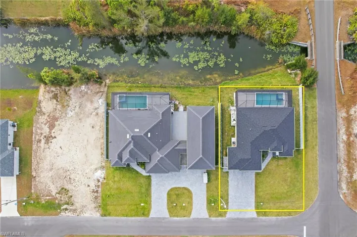 Aerial view of property's location with a nearby body of water and property parcel outlined