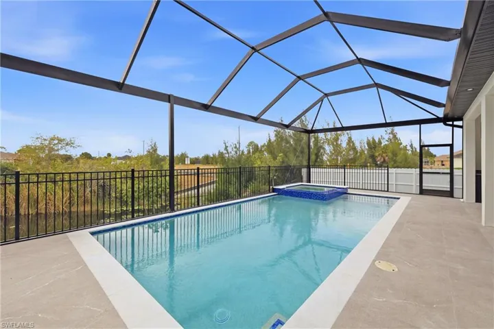 View of pool with a lanai, a sunroom, a pool with connected hot tub, and a patio