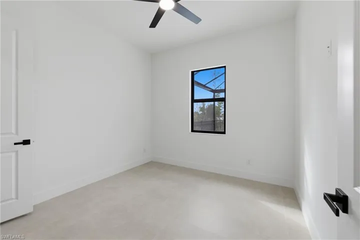Empty room with baseboards and a ceiling fan