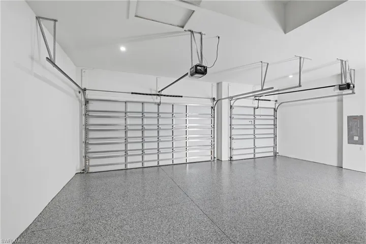 Garage with electric panel and a garage door opener