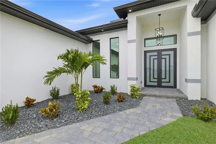 Doorway to property featuring stucco siding