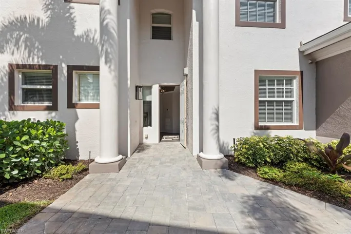 Entrance to property featuring stucco siding