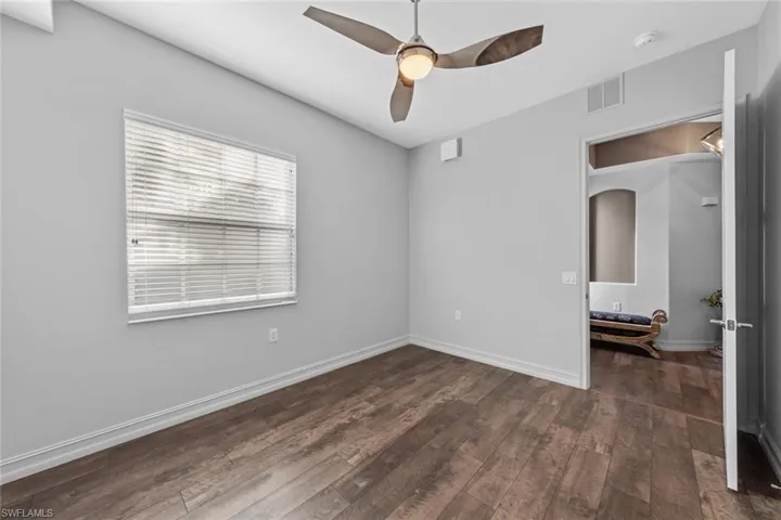 Unfurnished bedroom with hardwood / wood-style floors and a ceiling fan