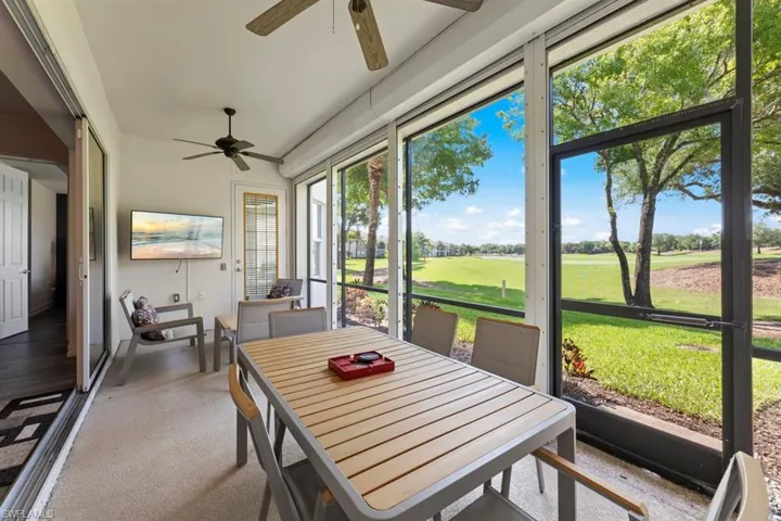 Sunroom / solarium featuring a ceiling fan and outdoor dining space