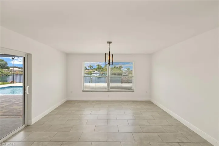 Unfurnished dining area featuring healthy amount of natural light and baseboards