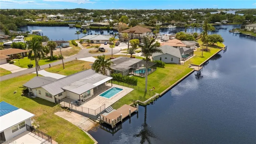 Aerial perspective of suburban area featuring a nearby body of water