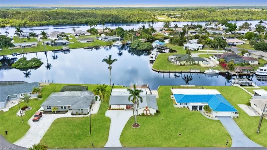 Virtually enhanced. Aerial view of residential area featuring a nearby body of water