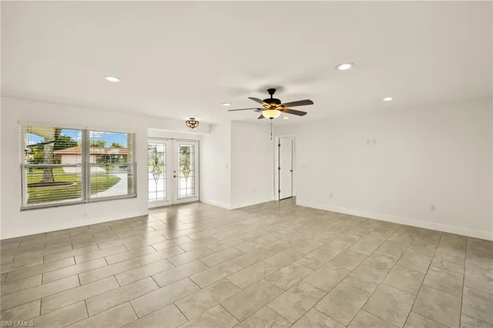 Spare room featuring recessed lighting, ceiling fan, french doors, and baseboards
