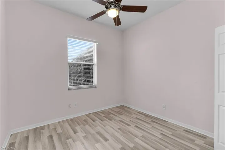 Empty room featuring light wood-style floors and a ceiling fan