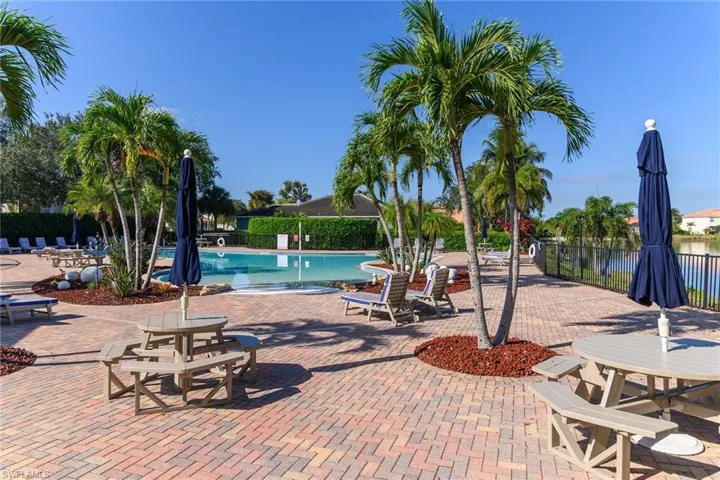 Community pool featuring a patio area and a water view