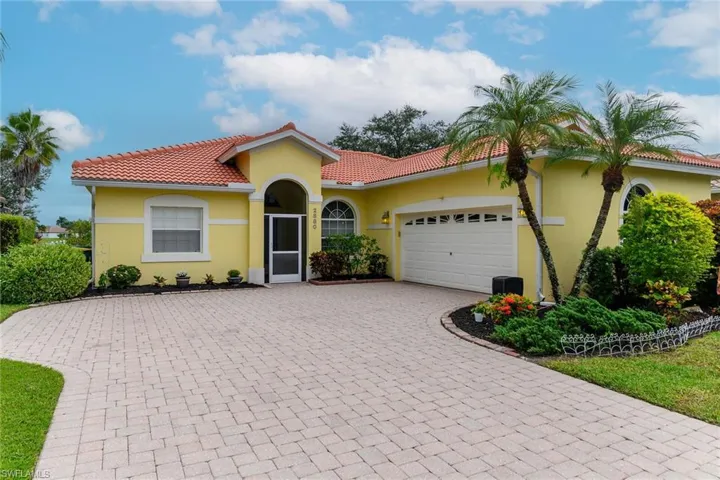 Mediterranean / spanish-style home with decorative driveway, an attached garage, stucco siding, and a tile roof