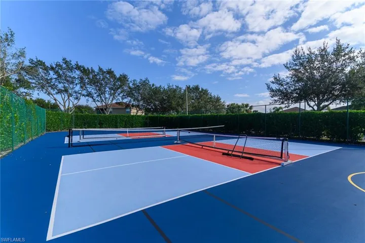 View of tennis court featuring community basketball court