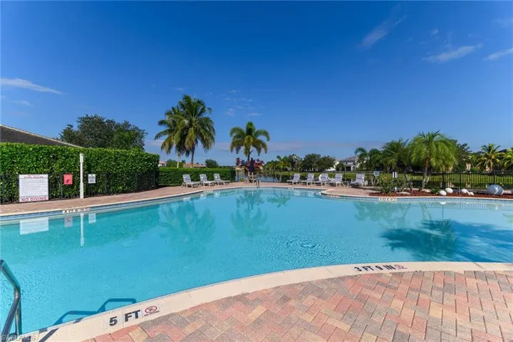 Community pool with a patio