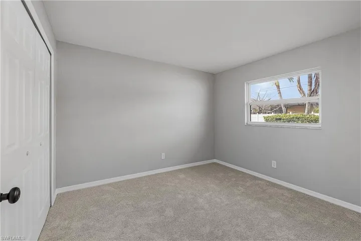 4014(L) Bedroom featuring new closet doors and light colored new carpet