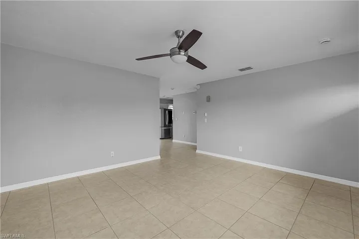 4014(L) Family room featuring a ceiling fan and light tile patterned floors